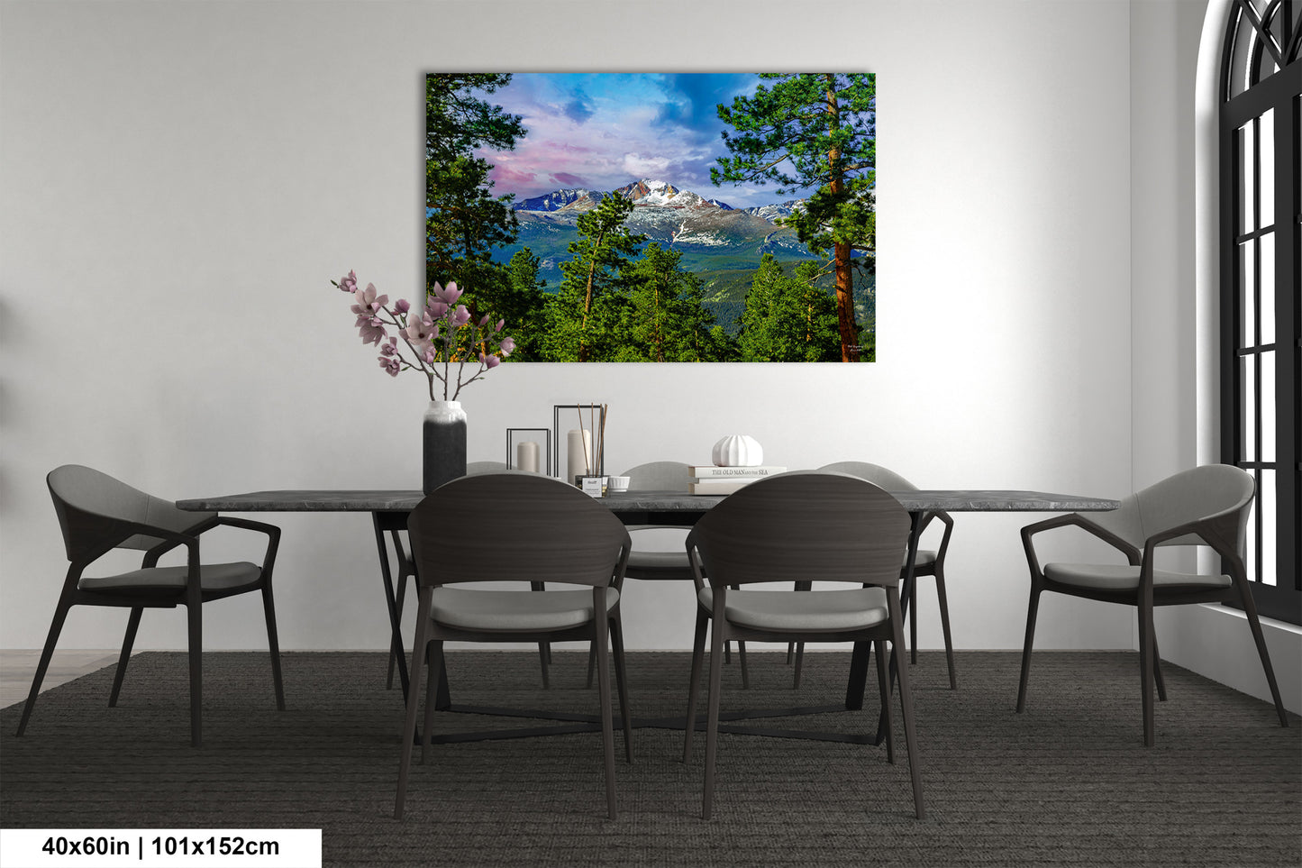 a dining room table with chairs and a painting on the wall