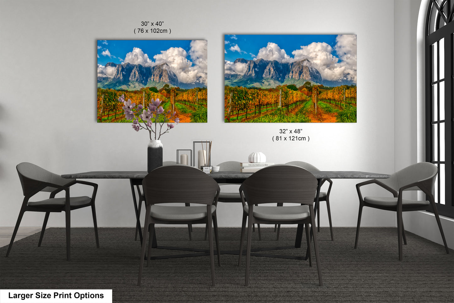 a dining room table with four chairs and a painting on the wall