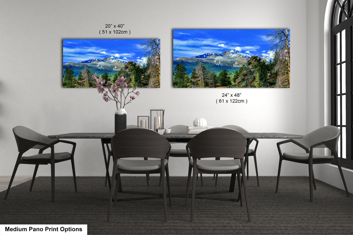 a dining room table with four chairs and a vase of flowers