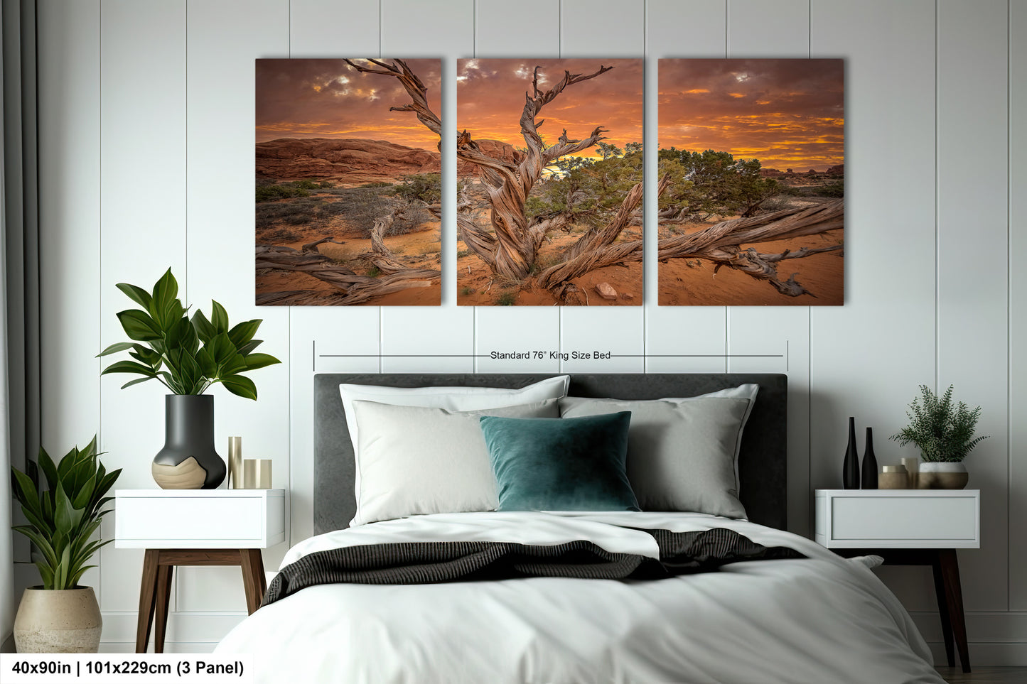 a bedroom with a bed and two paintings on the wall