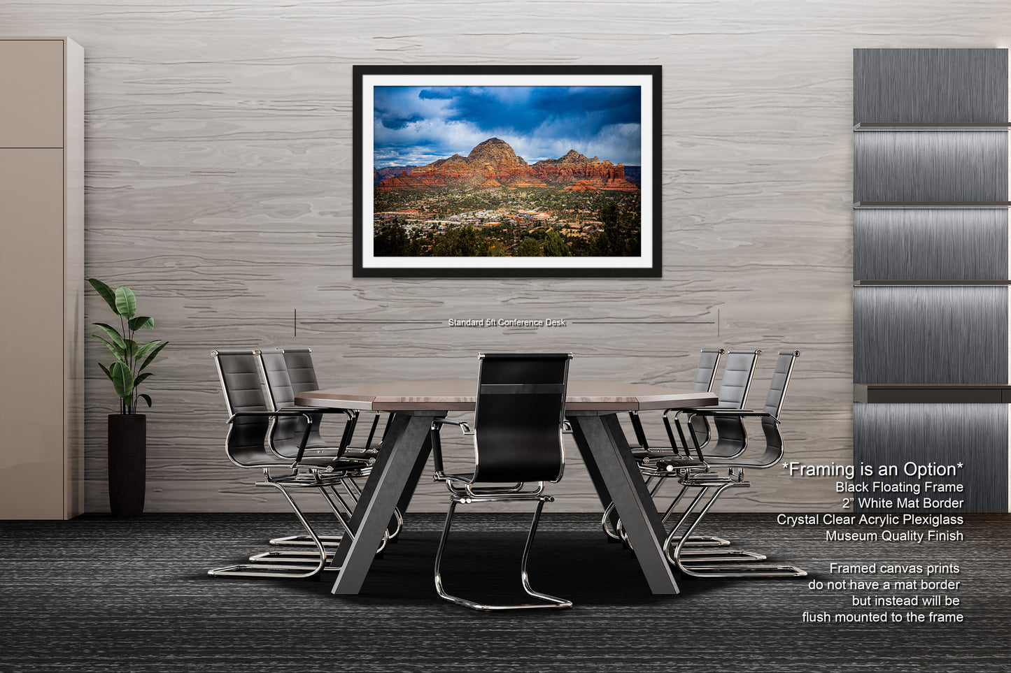 a dining room table with chairs and a picture hanging on the wall