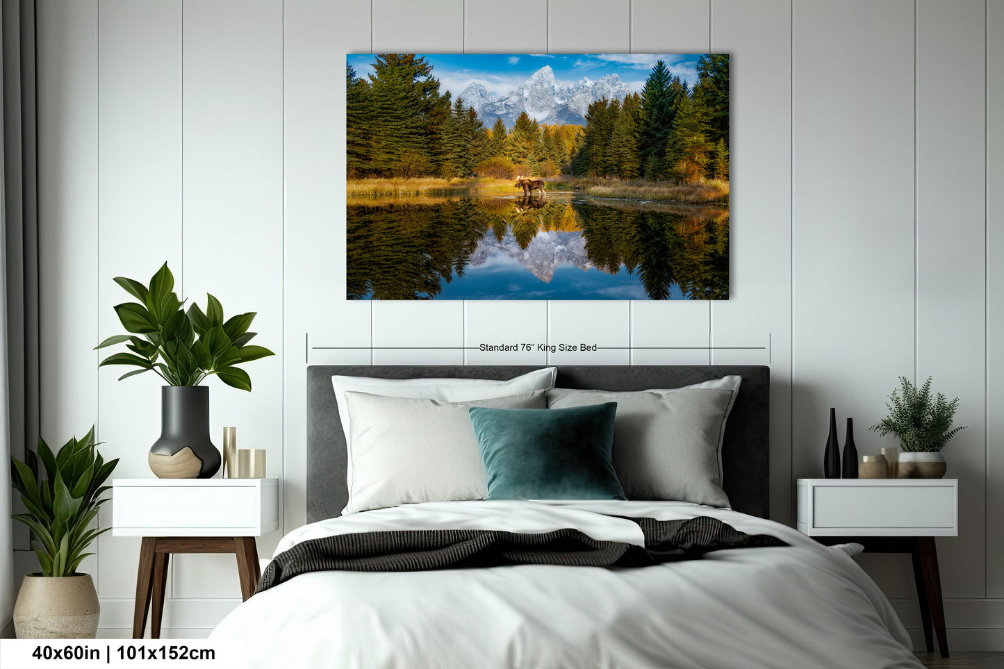 a bed room with a neatly made bed and a painting on the wall