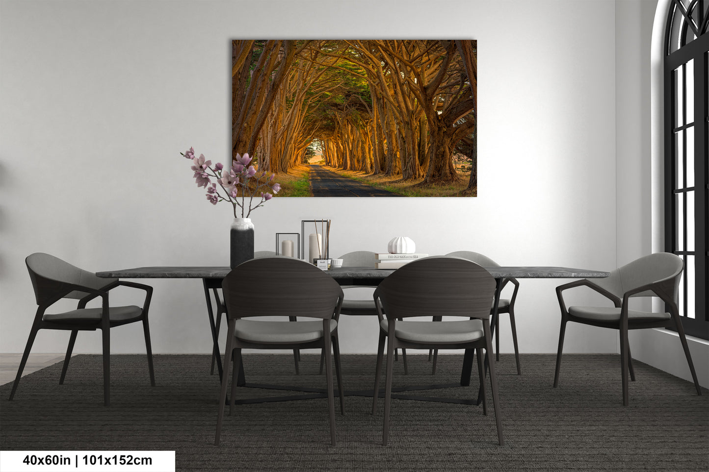 a dining room table with chairs and a painting on the wall
