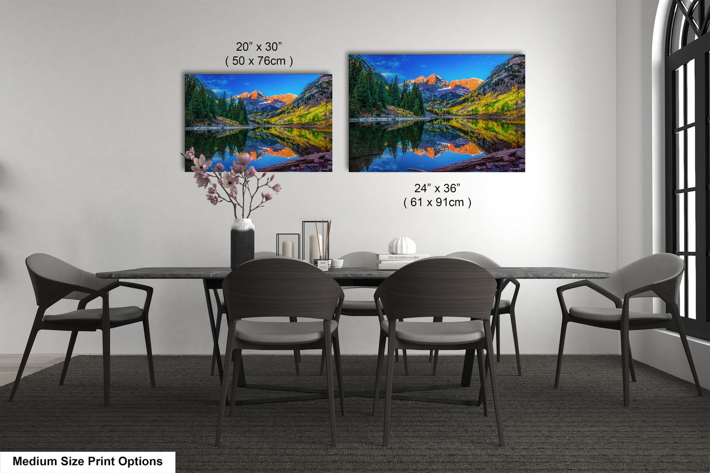 a dining room table with four chairs and a painting on the wall