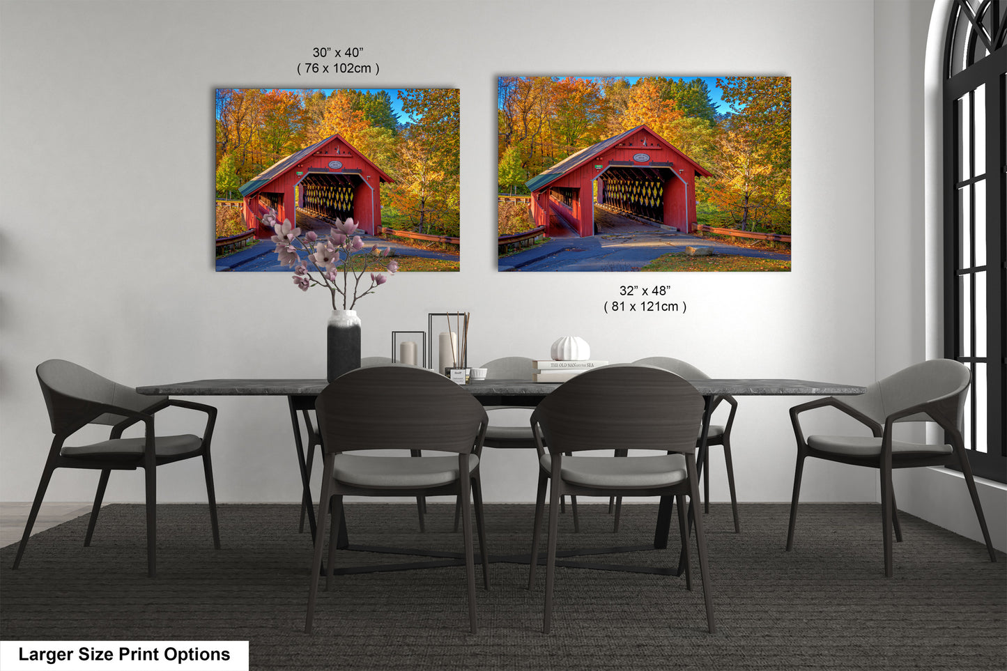 a dining room table with chairs and a painting of a covered bridge