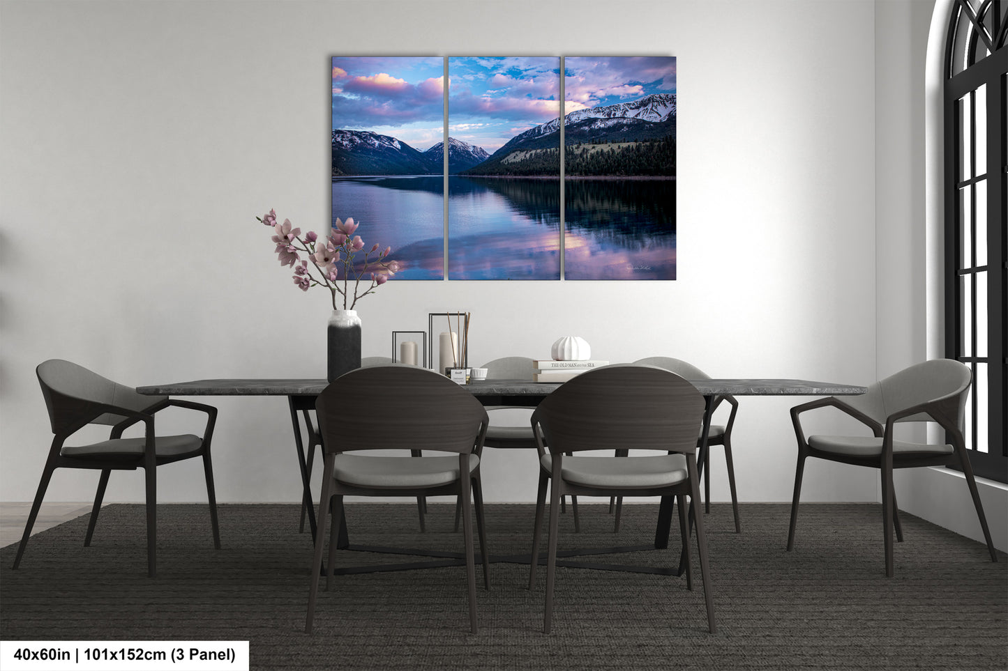 a dining room table with chairs and a painting on the wall