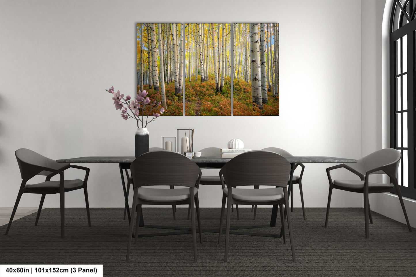 a dining room table with chairs and a painting on the wall