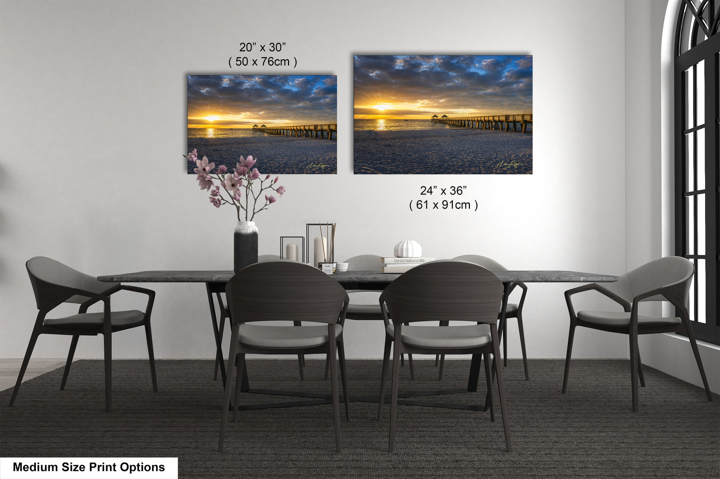 a dining table with four chairs and a vase with flowers