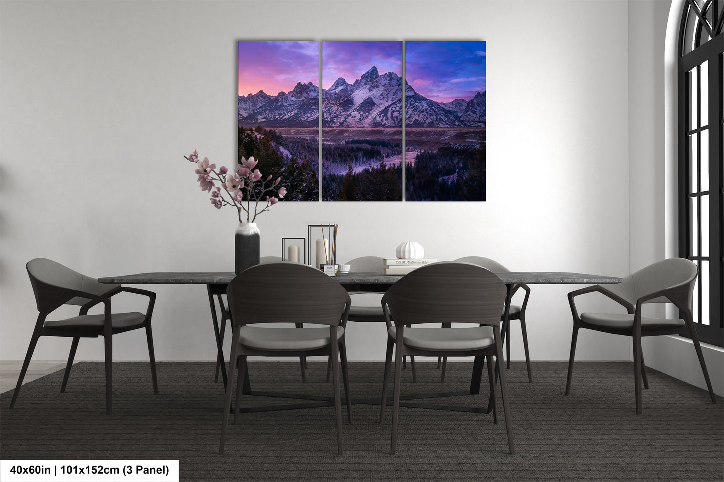 a dining room table with four chairs and a painting on the wall