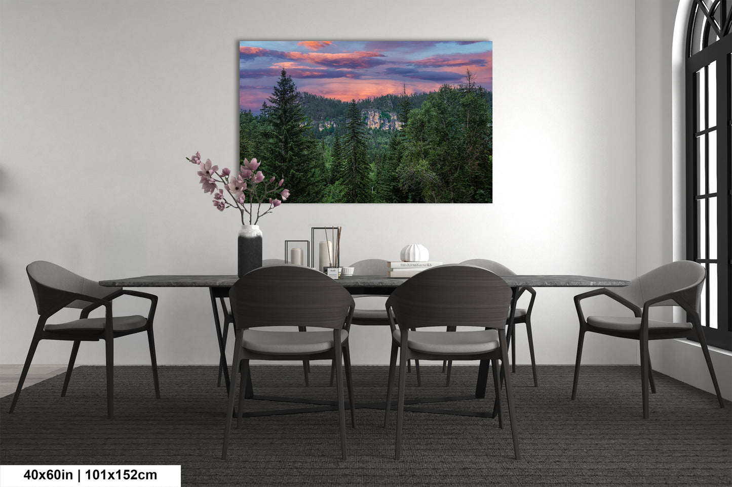 a dining room table with chairs and a painting on the wall