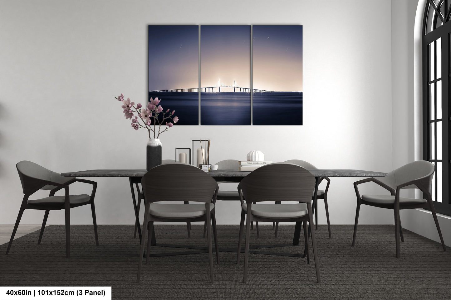 a dining room table with chairs and a painting on the wall