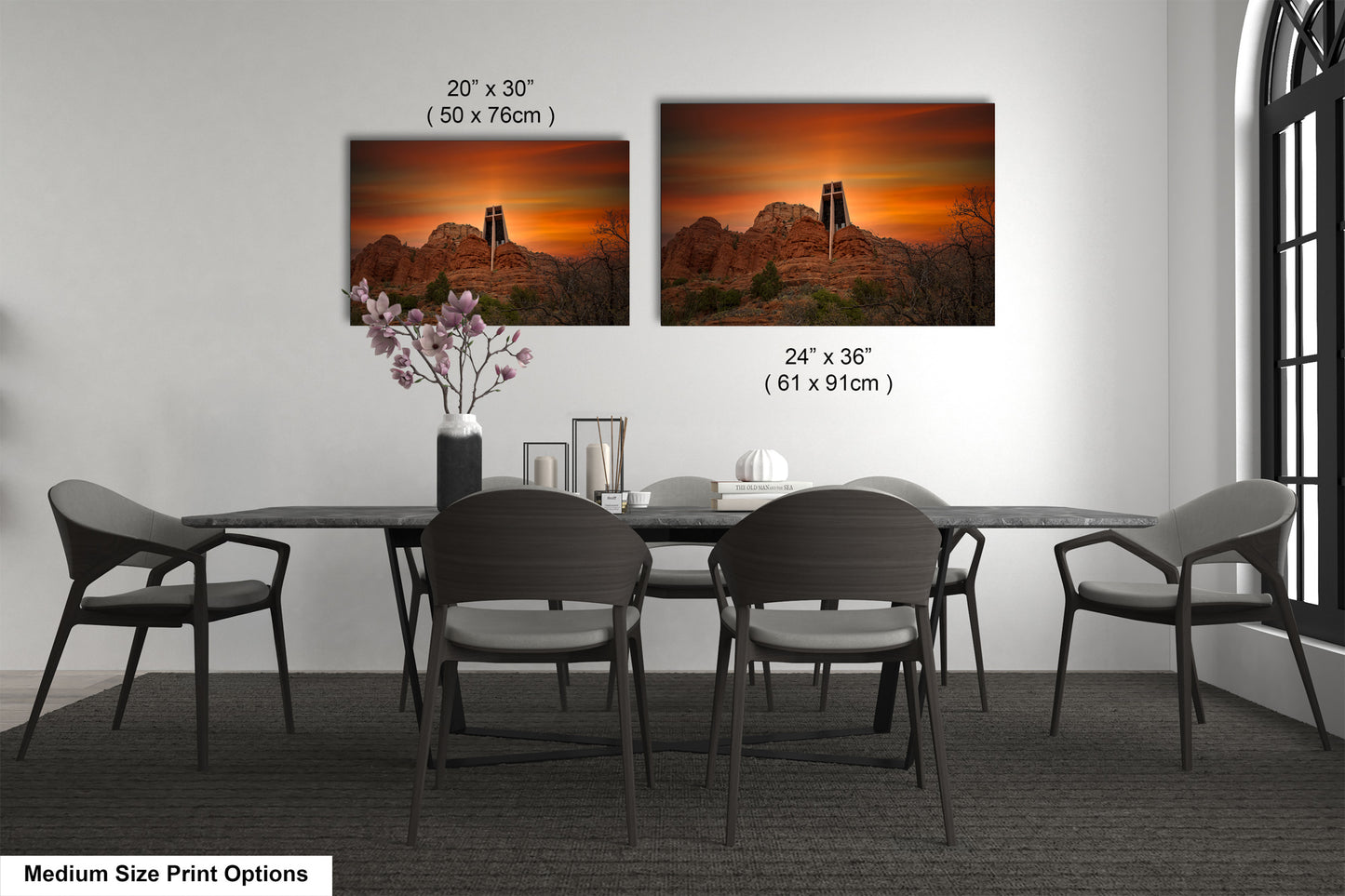 a dining table with four chairs and a vase of flowers