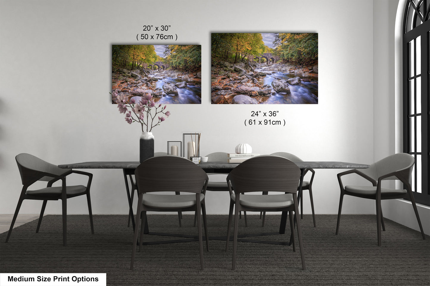 a dining table with four chairs and a vase of flowers