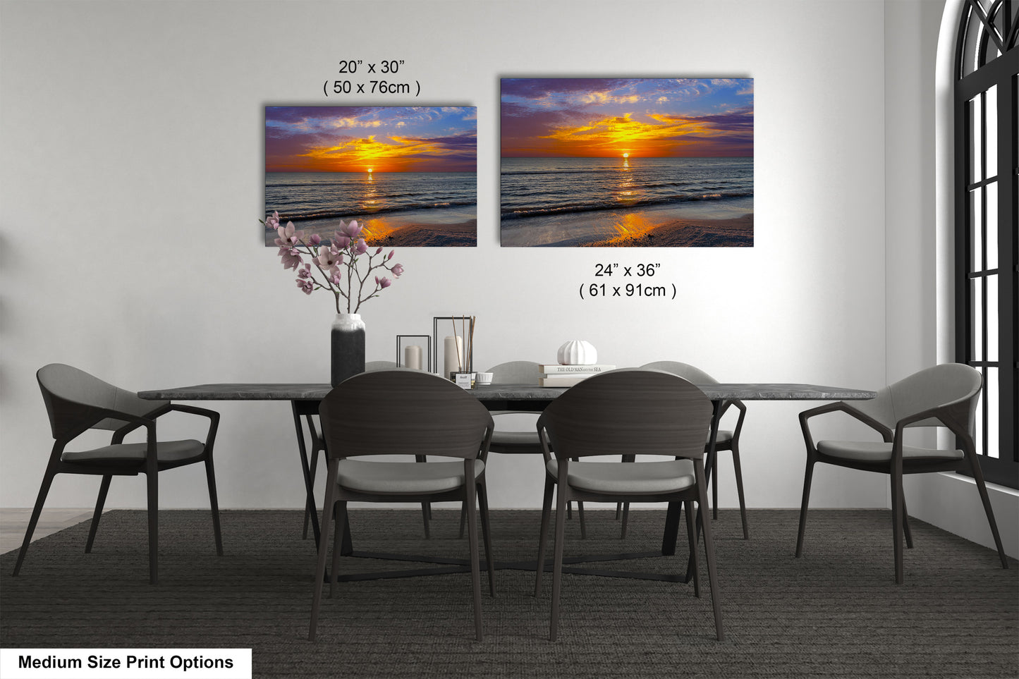 a dining room table with four chairs and a vase of flowers