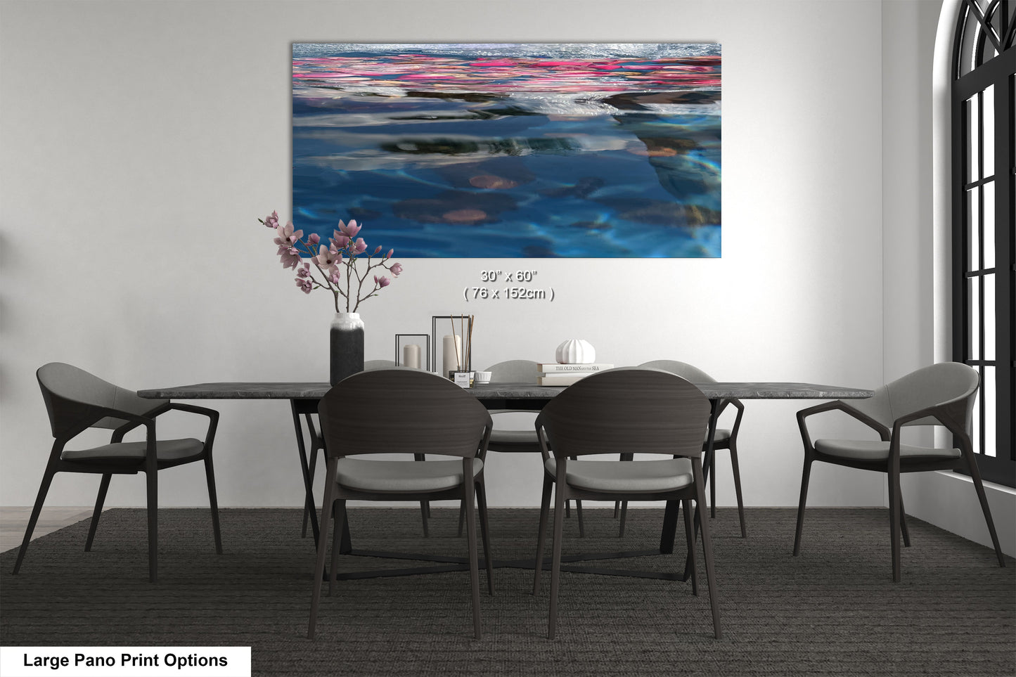 a dining room table with chairs and a painting on the wall