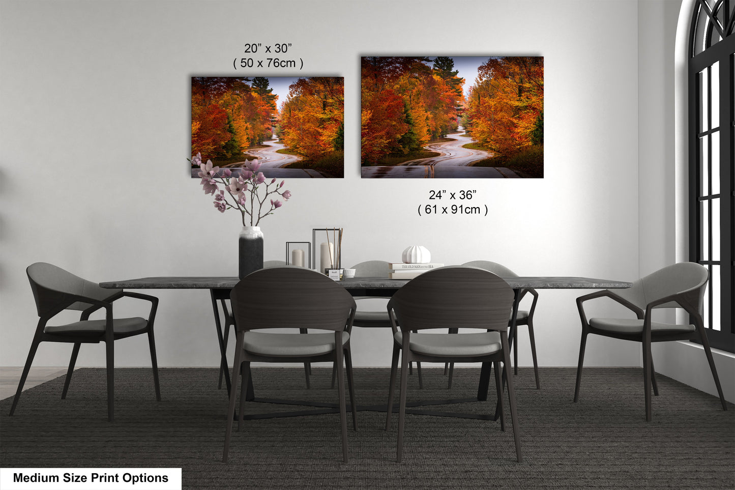 a dining table with four chairs and a vase of flowers