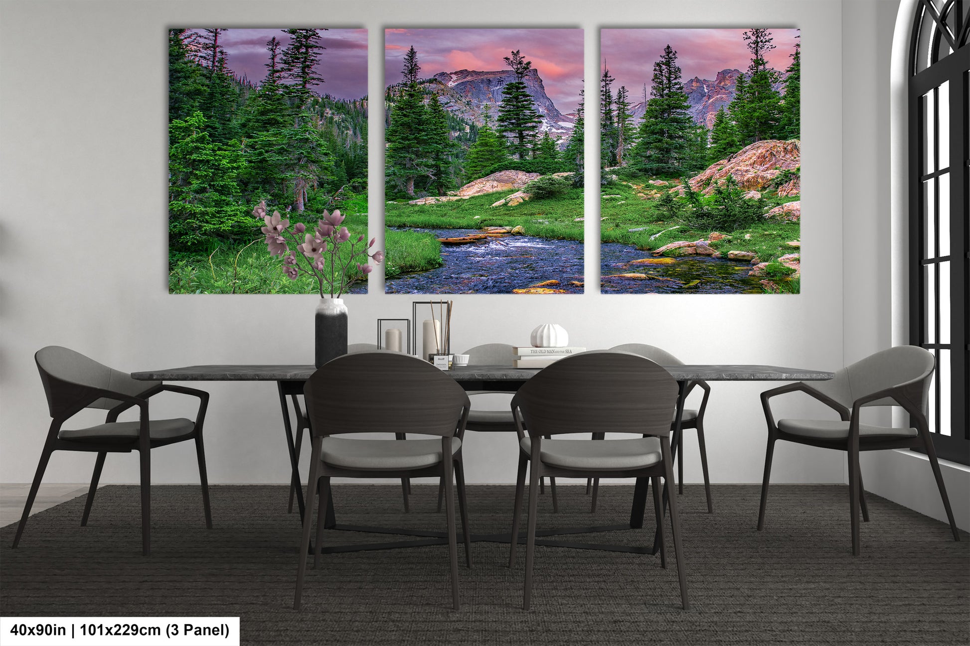 a dining room table with chairs and a painting on the wall