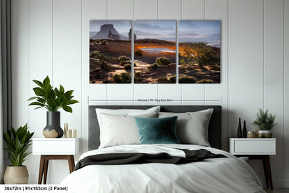 a bed room with a neatly made bed and a painting on the wall