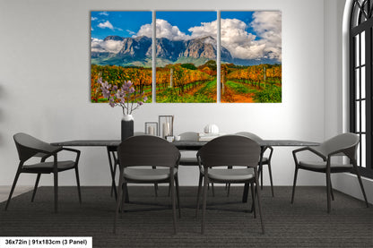 a dining room table with chairs and a painting on the wall