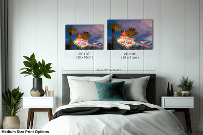 a bed room with a neatly made bed and two pictures on the wall