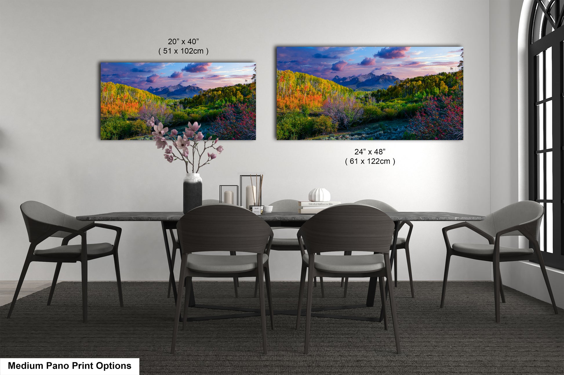 a dining room table with four chairs and a painting on the wall