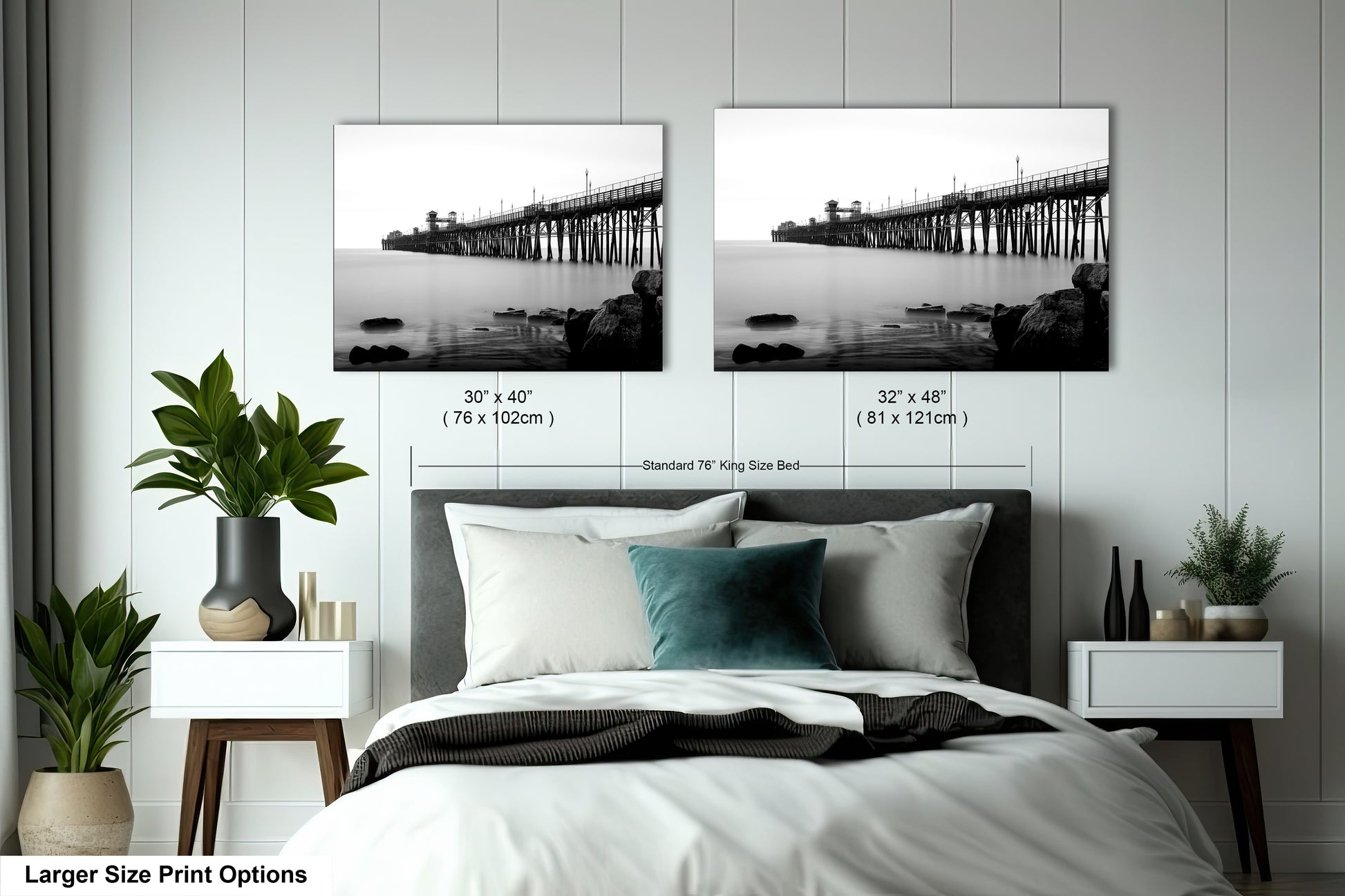 a bed with a white comforter and two black and white pictures on the wall