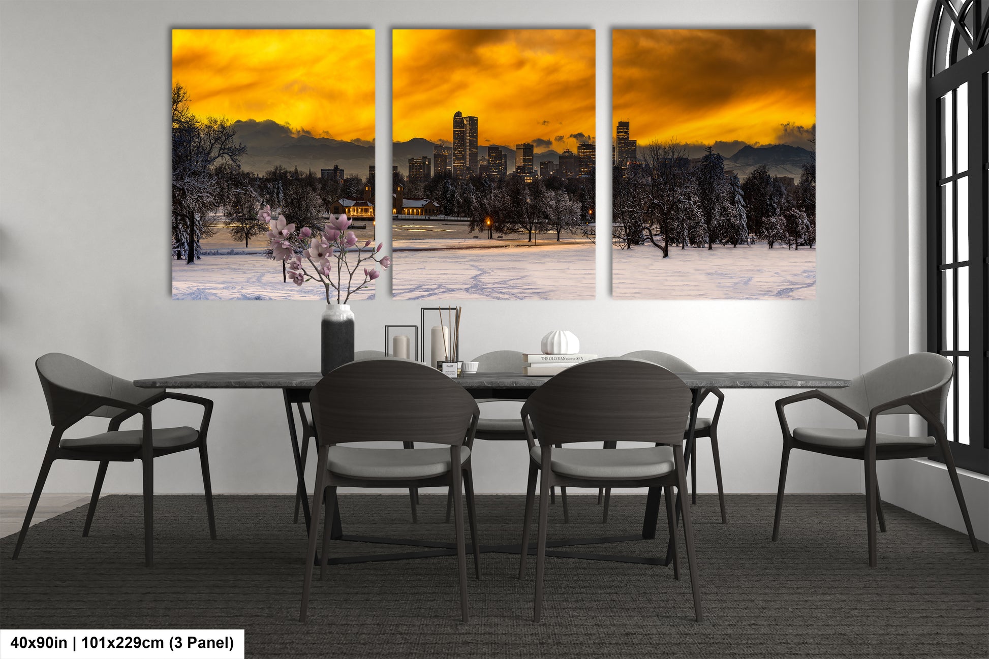 a dining room table with four chairs and a painting on the wall