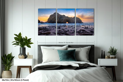 a bedroom with a bed and two paintings on the wall