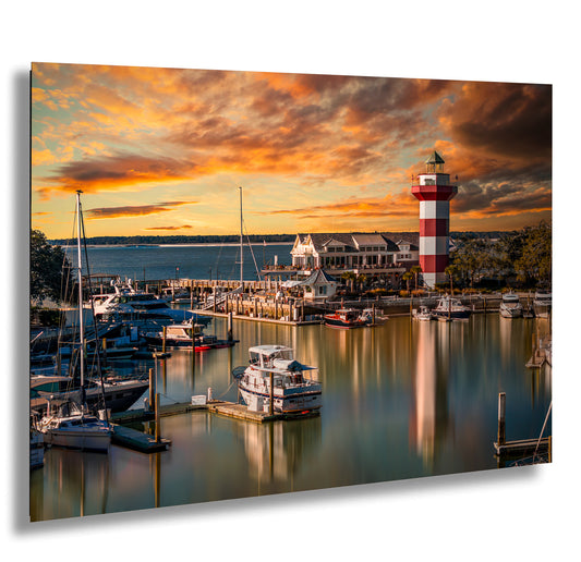 a harbor filled with lots of boats under a colorful sky