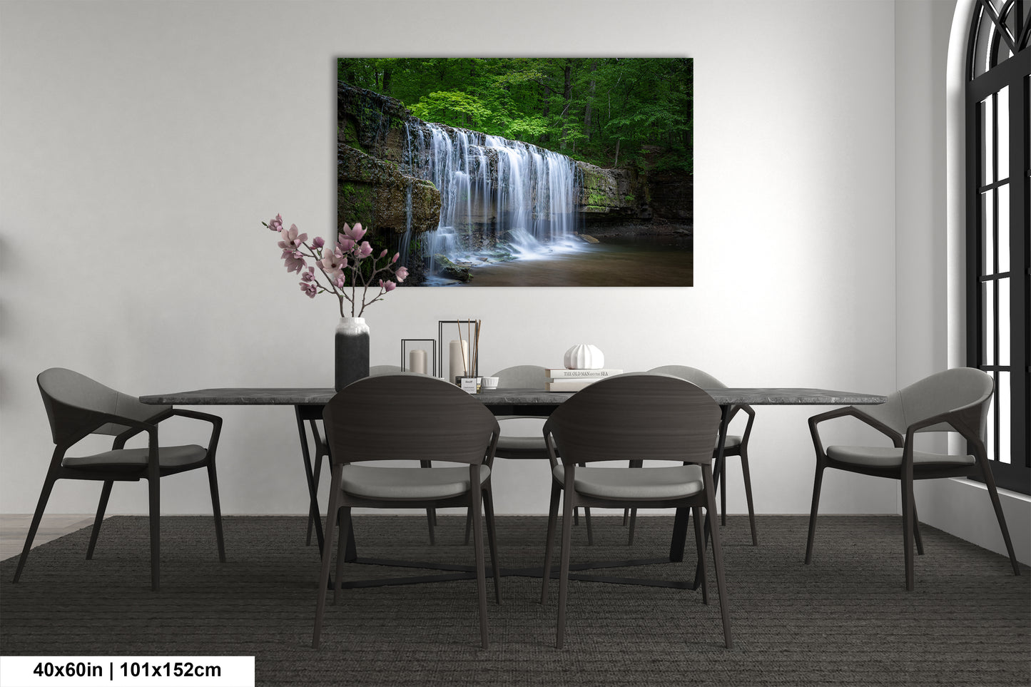 a dining room table with chairs and a painting on the wall