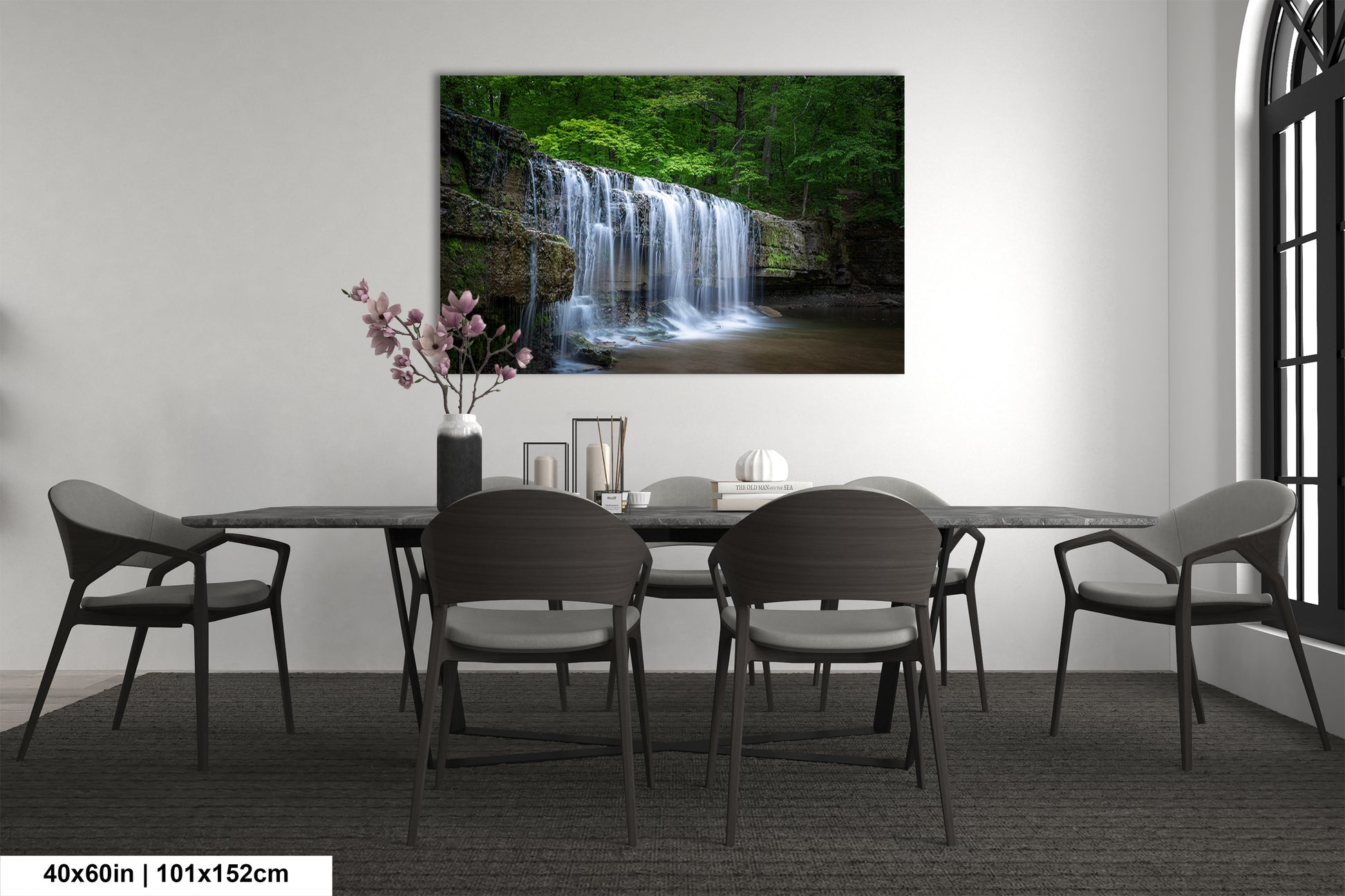 a dining room table with chairs and a painting on the wall