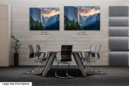 a dining room table with chairs and two pictures on the wall