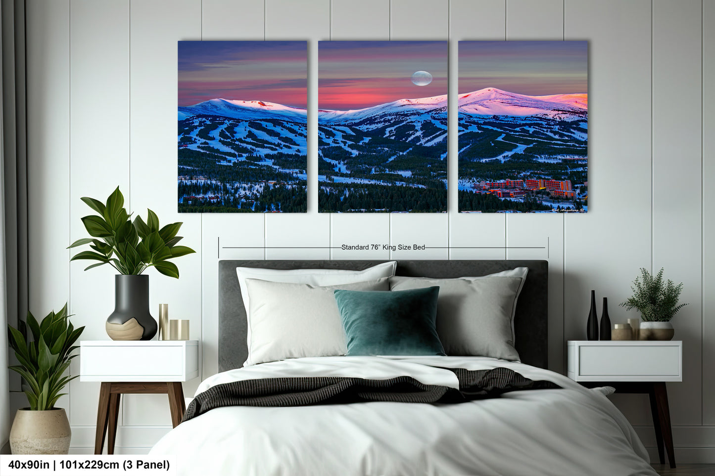 a bedroom with a bed and two paintings on the wall