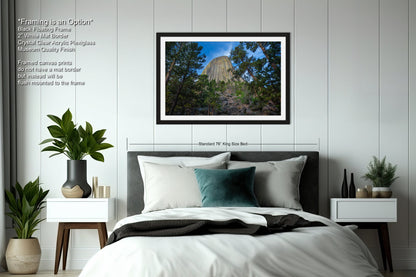 a bedroom with a bed and a picture hanging on the wall