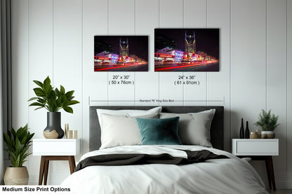 a bedroom with a bed and two pictures on the wall