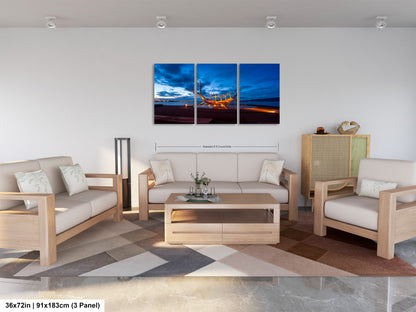a living room filled with furniture and a painting on the wall