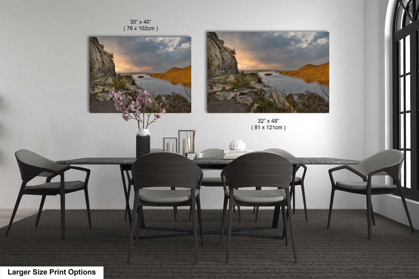 a dining room table with four chairs and a vase of flowers