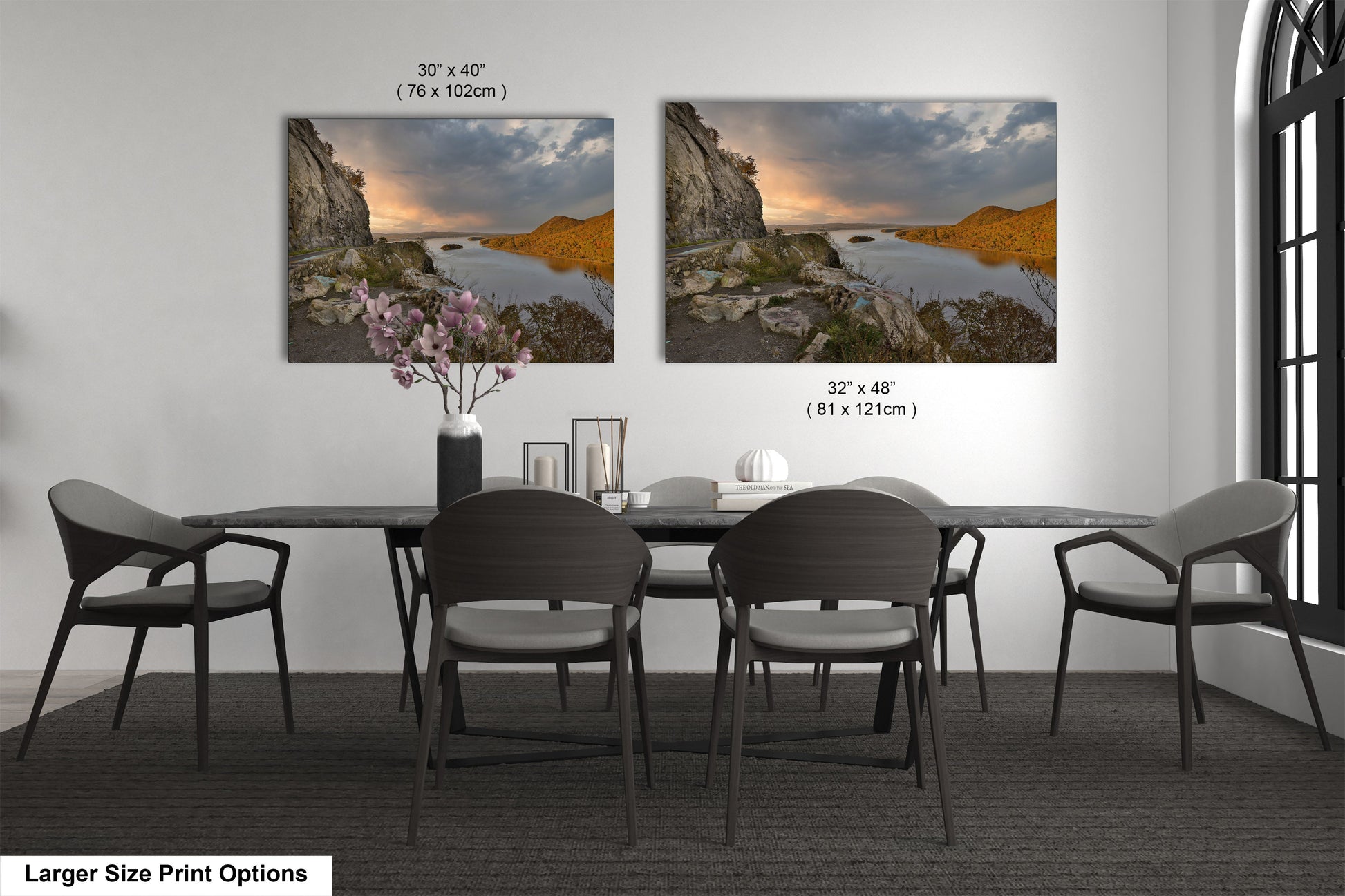 a dining room table with four chairs and a vase of flowers