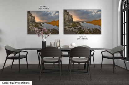 a dining room table with four chairs and a vase of flowers