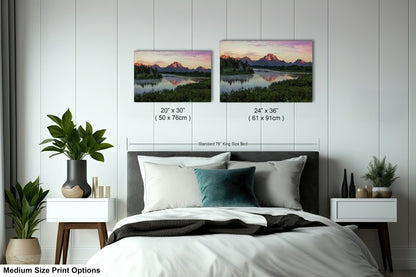 a bed with two pictures on the wall above it