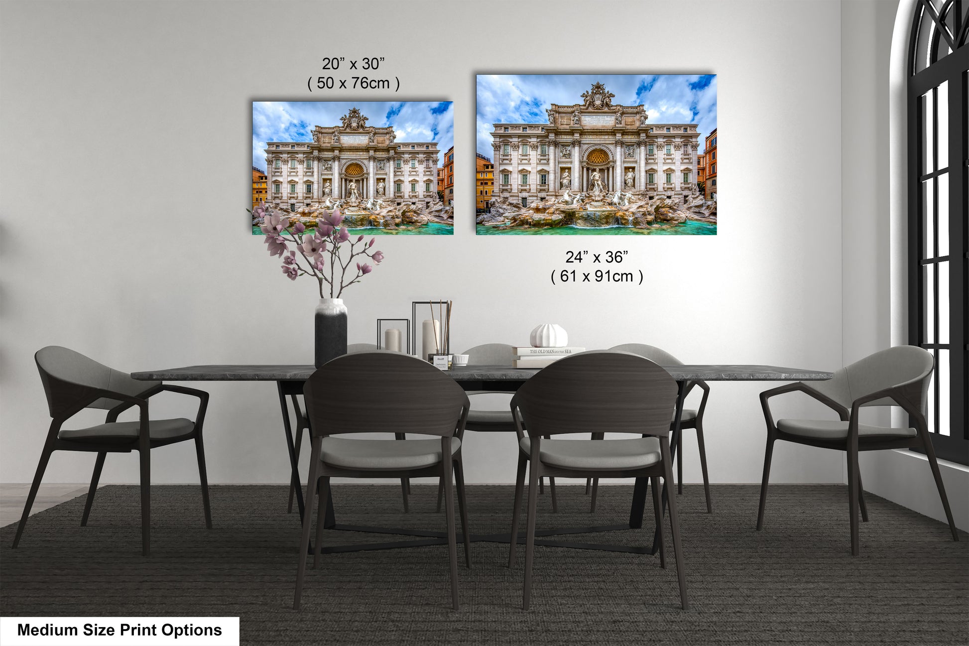 a dining room table with four chairs and a vase of flowers