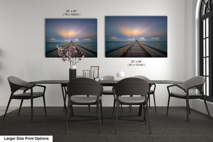 a dining table with four chairs and a vase of flowers