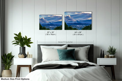 a bedroom with a bed and two pictures on the wall