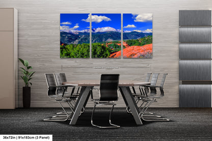a dining room with a table and chairs with mountains in the background