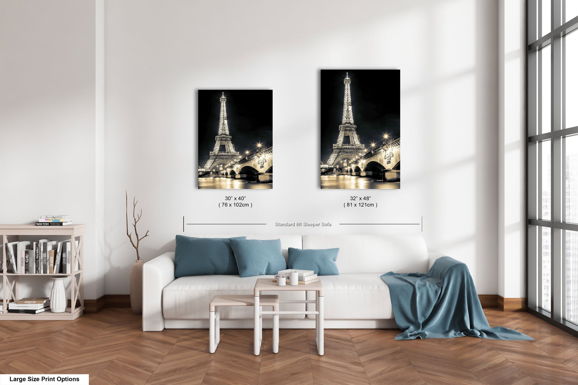 a living room with a white couch and two pictures of the eiffel tower