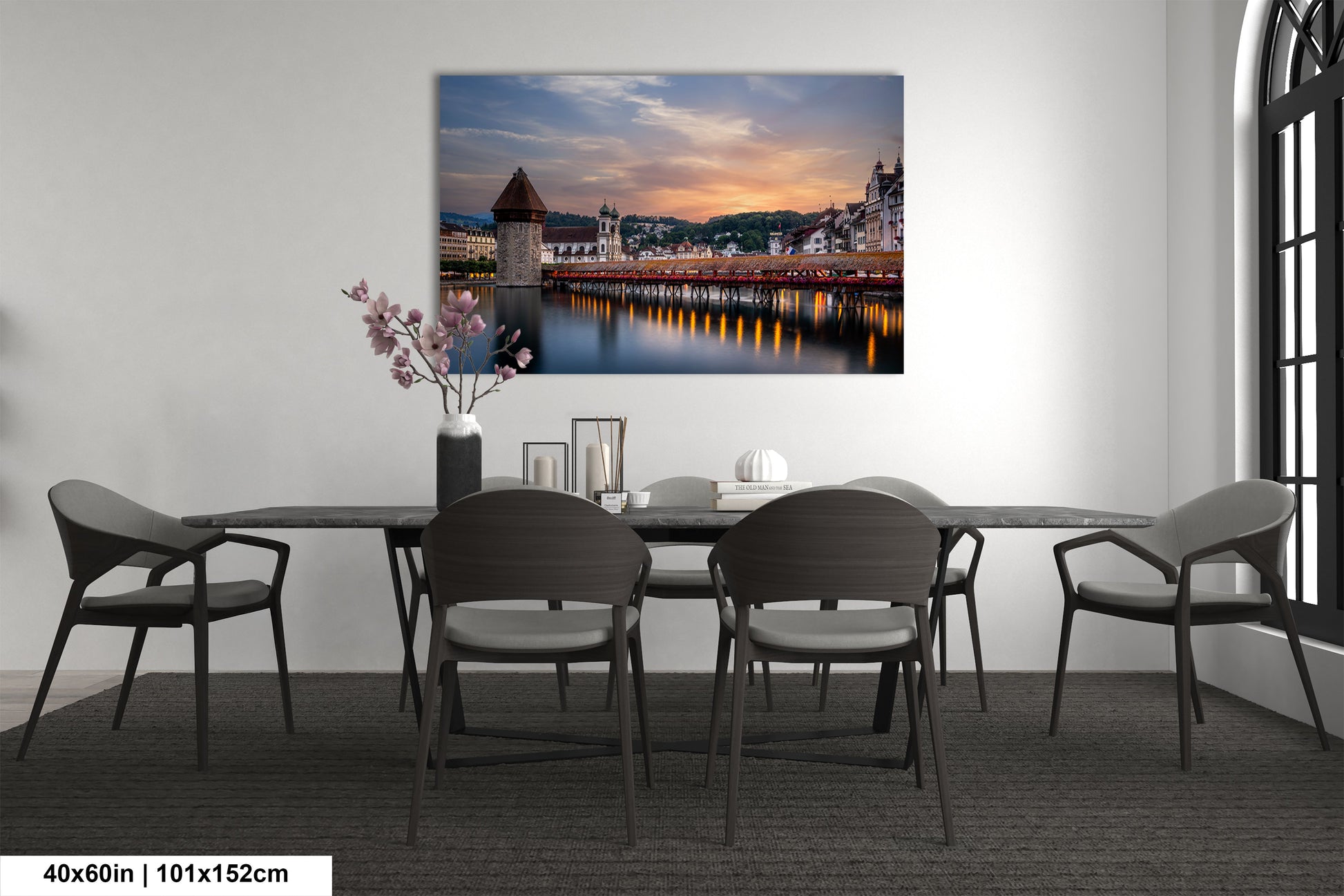 a room with a table and chairs and a painting on the wall