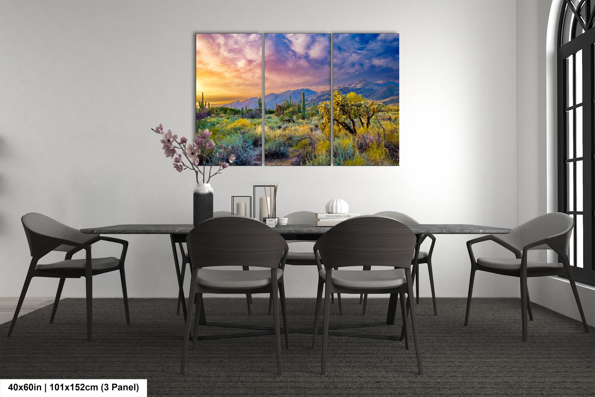 a dining room table with chairs and a painting on the wall