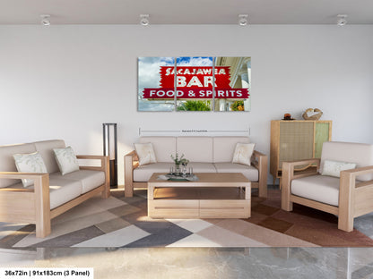 a living room filled with furniture and a painting on the wall