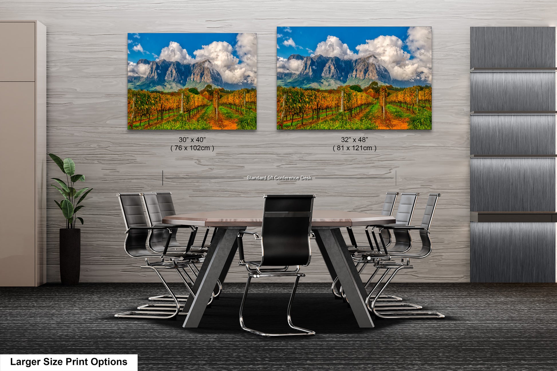 a dining room table with chairs in front of two pictures of mountains