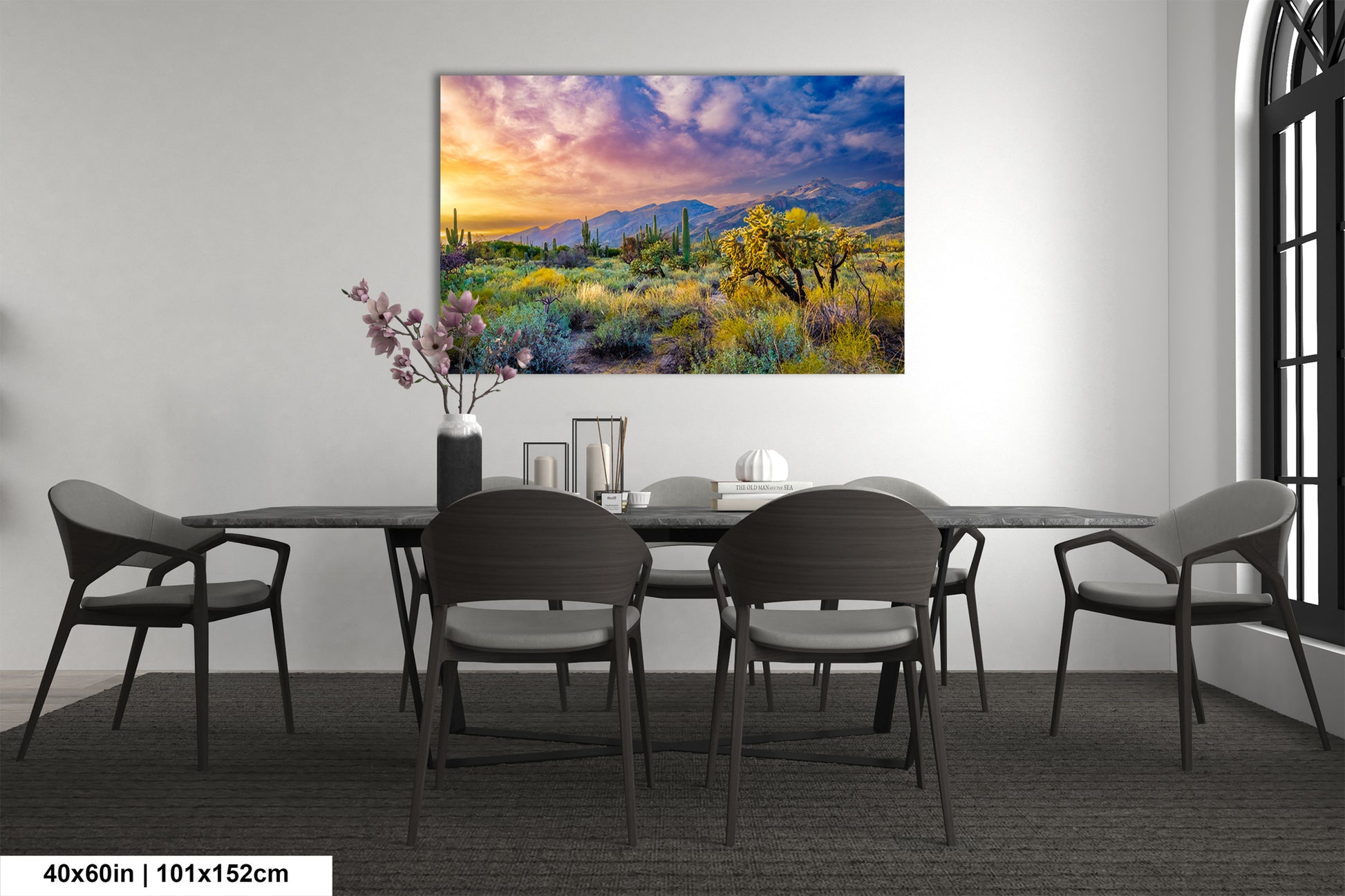 a dining room with a table and chairs and a painting on the wall